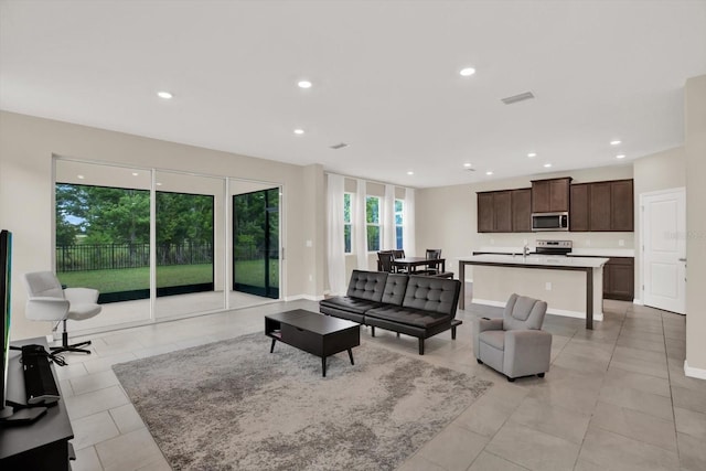 10379 Bridgegate Heights Loop, San Antonio, FL 33576 - living room featuring recessed lighting, light tile patterned floors, and baseboards