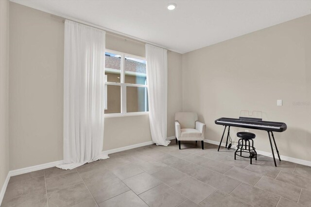 10379 Bridgegate Heights Loop, San Antonio, FL 33576 - sitting room with baseboards and tile patterned flooring