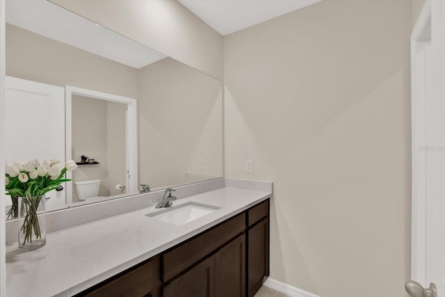 10379 Bridgegate Heights Loop, San Antonio, FL 33576 - bathroom with toilet, vanity, and baseboards