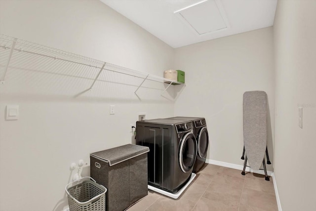 10379 Bridgegate Heights Loop, San Antonio, FL 33576 - laundry area featuring washer and clothes dryer, baseboards, light tile patterned floors, and attic access