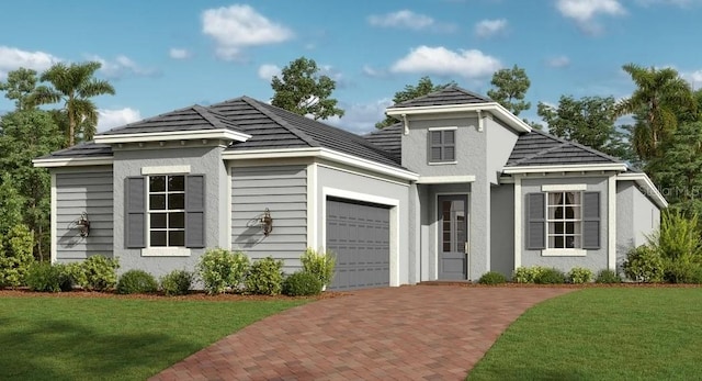 view of front of home with an attached garage, decorative driveway, a front yard, and stucco siding