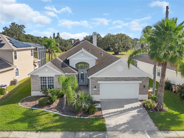 1530 The Oaks Blvd, Kissimmee, FL 34746 - view of front facade with central AC unit, a garage, concrete driveway, a front yard, and brick siding