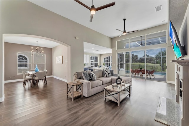 1530 The Oaks Blvd, Kissimmee, FL 34746 - living area featuring arched walkways, ceiling fan, wood finished floors, a chandelier, and baseboards
