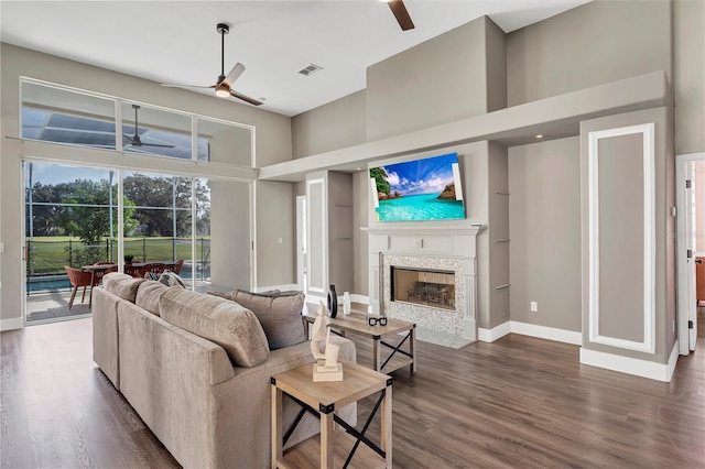 1530 The Oaks Blvd, Kissimmee, FL 34746 - living room with ceiling fan, a high ceiling, wood finished floors, and baseboards
