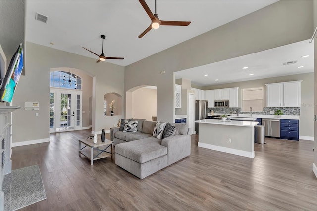 1530 The Oaks Blvd, Kissimmee, FL 34746 - living area with ceiling fan, arched walkways, a towering ceiling, wood finished floors, and recessed lighting