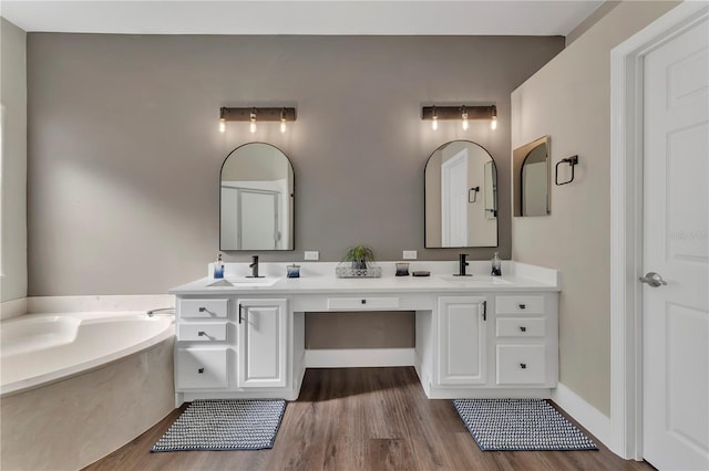 1530 The Oaks Blvd, Kissimmee, FL 34746 - full bathroom with wood finished floors, double vanity, and a bath