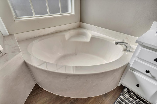 1530 The Oaks Blvd, Kissimmee, FL 34746 - full bath featuring wood finished floors, a bath, and vanity