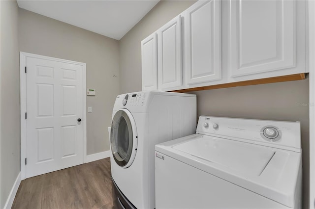 1530 The Oaks Blvd, Kissimmee, FL 34746 - clothes washing area featuring independent washer and dryer, cabinet space, dark wood-style flooring, and baseboards