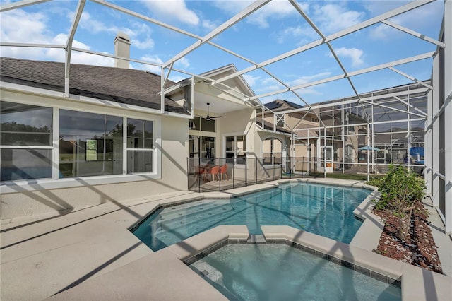 1530 The Oaks Blvd, Kissimmee, FL 34746 - view of swimming pool with a patio area, a pool with connected hot tub, ceiling fan, and glass enclosure