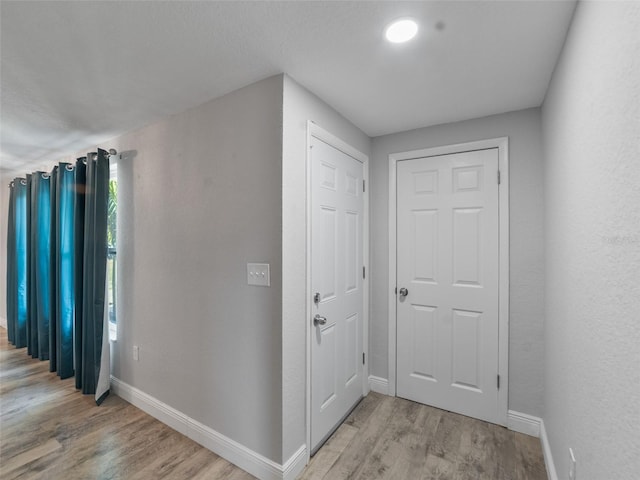 4238 Glissade Dr, New Port Richey, FL 34652 - hallway with light wood finished floors and baseboards