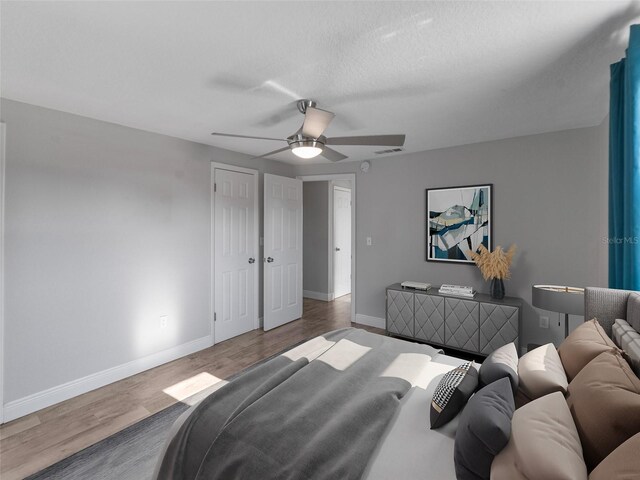 4238 Glissade Dr, New Port Richey, FL 34652 - bedroom with wood finished floors, baseboards, and a ceiling fan