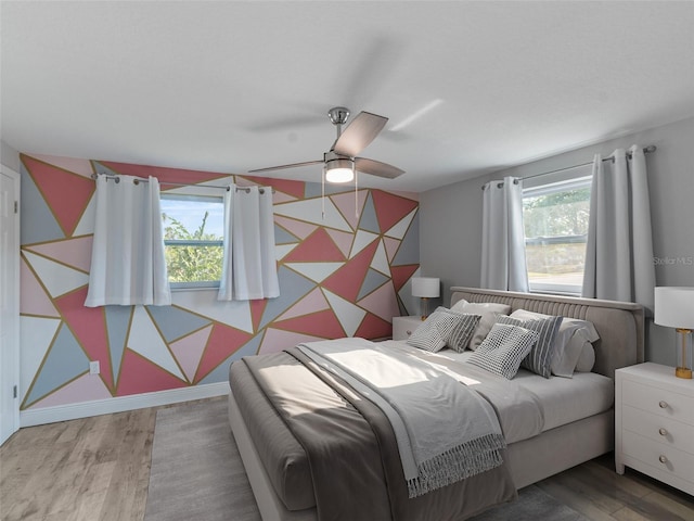 4238 Glissade Dr, New Port Richey, FL 34652 - bedroom featuring wood finished floors, ceiling fan, and baseboards