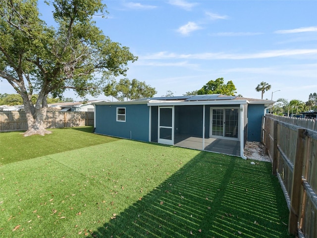 4238 Glissade Dr, New Port Richey, FL 34652 - rear view of house with solar panels, stucco siding, and a patio