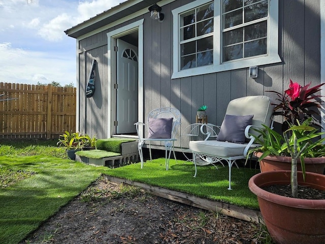 view of exterior entry featuring fence