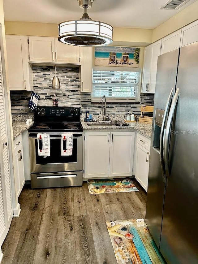 kitchen featuring appliances with stainless steel finishes, a sink, and white cabinets