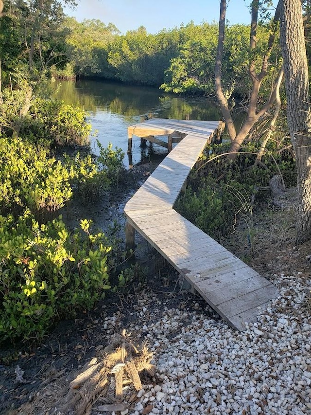 dock featuring a water view and a wooded view