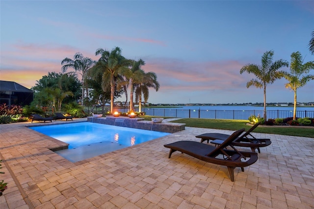 view of pool featuring a patio and a water view