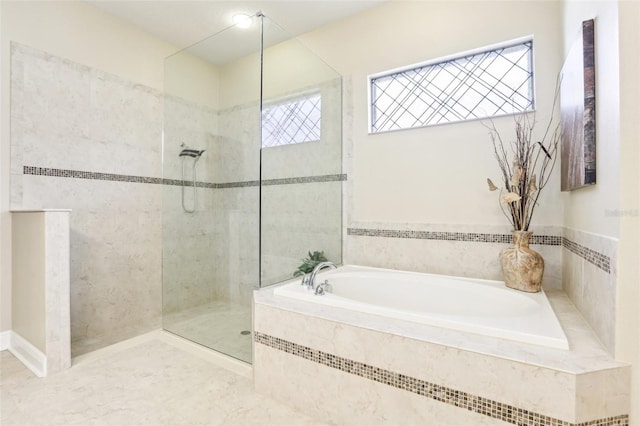 full bathroom featuring a walk in shower and a garden tub