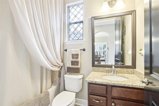 bathroom featuring vanity, toilet, and shower / bath combo with shower curtain