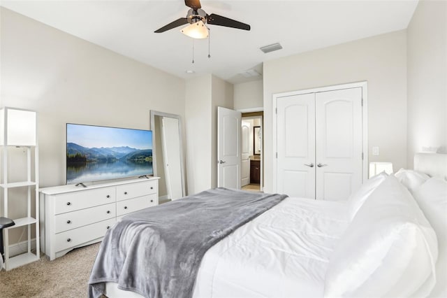 bedroom featuring light colored carpet, a closet, and ceiling fan