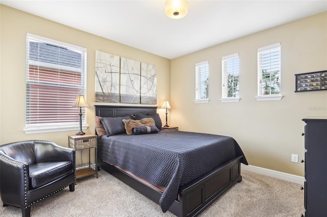 bedroom with carpet floors and baseboards