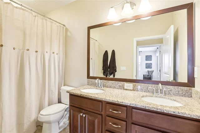 bathroom with toilet and double vanity