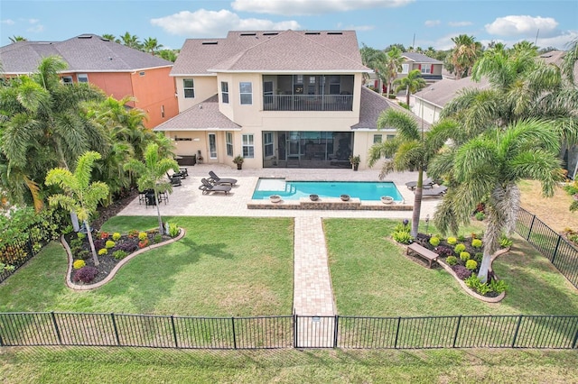 back of property featuring stucco siding, a sunroom, a shingled roof, and a patio area