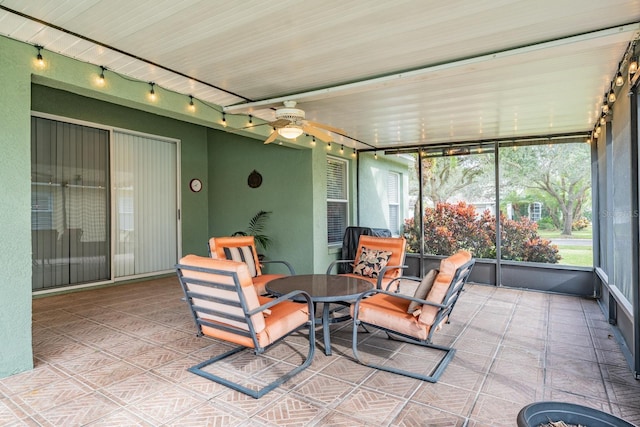 sunroom featuring ceiling fan