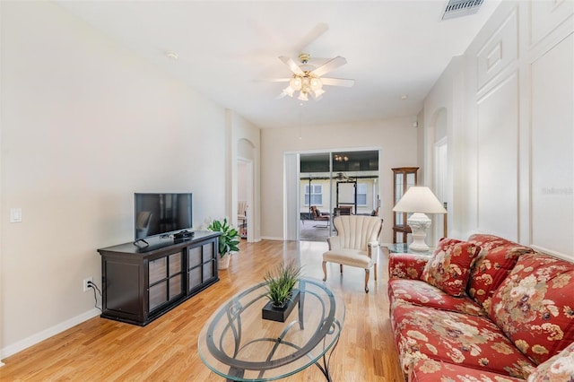 living area with ceiling fan, wood finished floors, and baseboards