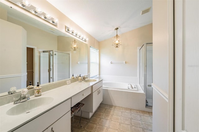 bathroom with a garden tub, a shower stall, a chandelier, double vanity, and tile patterned floors