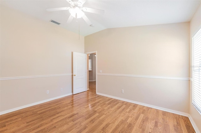 unfurnished room with light wood-type flooring, ceiling fan, baseboards, and vaulted ceiling