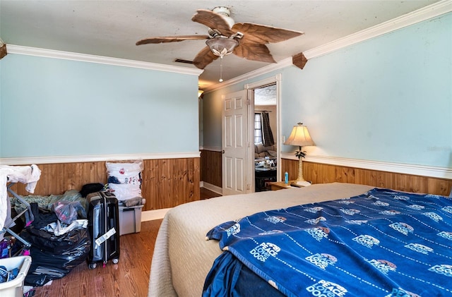 504 Casas Bonitas Dr, Nokomis, FL 34275 - bedroom with wood finished floors, a wainscoted wall, ornamental molding, wood walls, and ceiling fan