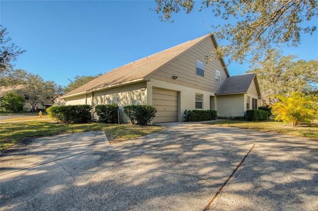2870 Rampart Cir, Clearwater, FL 33761 - view of side of property with driveway, stucco siding, and an attached garage