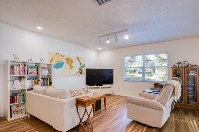 2870 Rampart Cir, Clearwater, FL 33761 - living area featuring wood finished floors, a textured ceiling, recessed lighting, baseboards, and track lighting