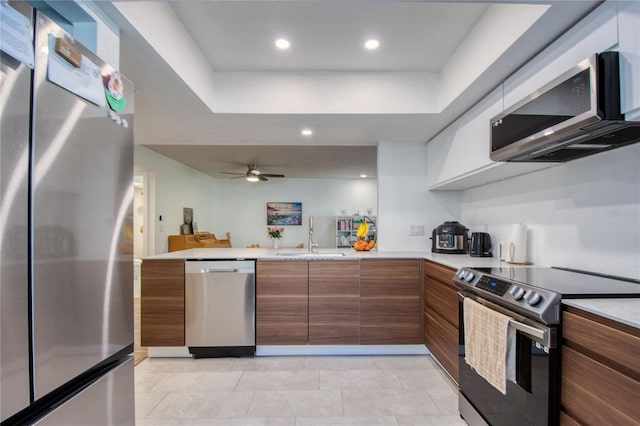 2870 Rampart Cir, Clearwater, FL 33761 - kitchen featuring stainless steel appliances, a sink, brown cabinets, modern cabinets, and light countertops