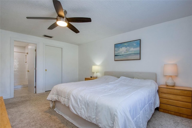 2870 Rampart Cir, Clearwater, FL 33761 - bedroom with a textured ceiling, ensuite bath, a ceiling fan, and carpet flooring
