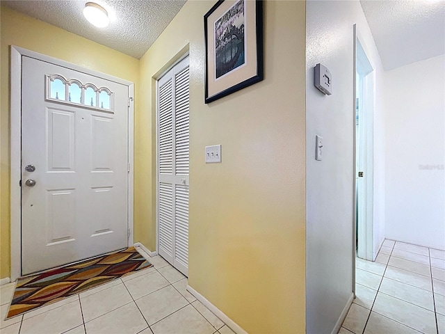 10520 Tapestry Dr, Port Richey, FL 34668 - entryway featuring a textured ceiling and light tile patterned flooring