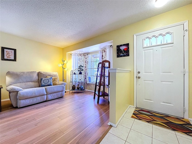 10520 Tapestry Dr, Port Richey, FL 34668 - foyer entrance with a textured ceiling and light wood-style flooring