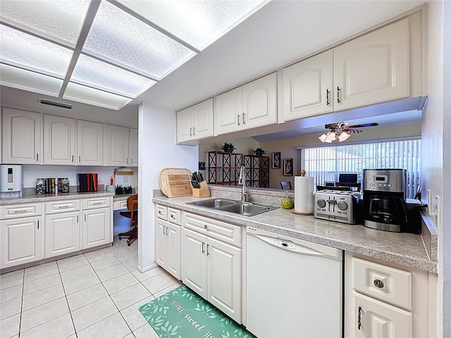 10520 Tapestry Dr, Port Richey, FL 34668 - kitchen with dishwasher, light tile patterned floors, light countertops, and white cabinetry
