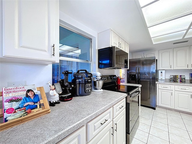 10520 Tapestry Dr, Port Richey, FL 34668 - kitchen with electric stove, stainless steel refrigerator with ice dispenser, light tile patterned floors, light countertops, and white cabinetry