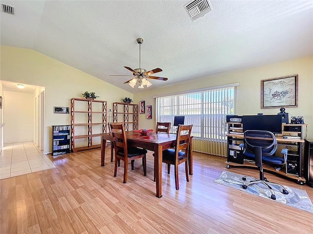 10520 Tapestry Dr, Port Richey, FL 34668 - dining area featuring a ceiling fan, an office area, lofted ceiling, a textured ceiling, and light wood-type flooring