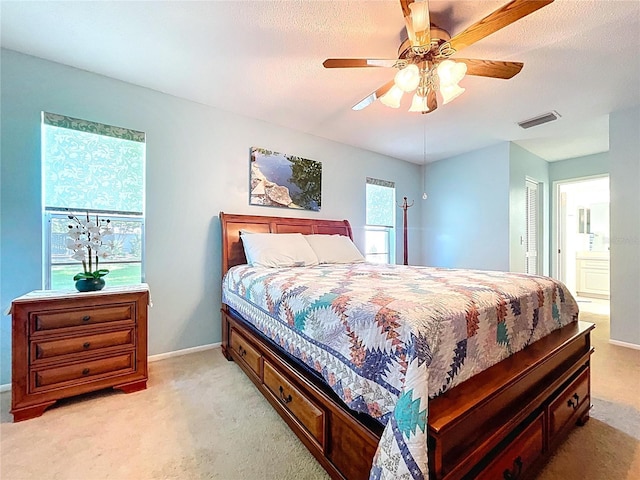 10520 Tapestry Dr, Port Richey, FL 34668 - bedroom featuring light colored carpet, a ceiling fan, and connected bathroom