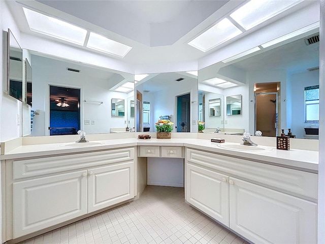 10520 Tapestry Dr, Port Richey, FL 34668 - bathroom with a shower stall, a skylight, tile patterned flooring, and double vanity