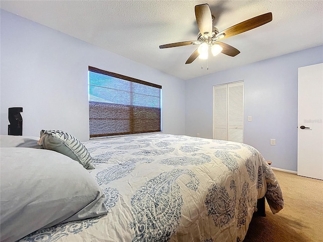 10520 Tapestry Dr, Port Richey, FL 34668 - bedroom featuring light carpet, a closet, ceiling fan, and a textured ceiling