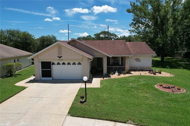 10520 Tapestry Dr, Port Richey, FL 34668 - ranch-style home featuring a front lawn, driveway, a garage, and brick siding