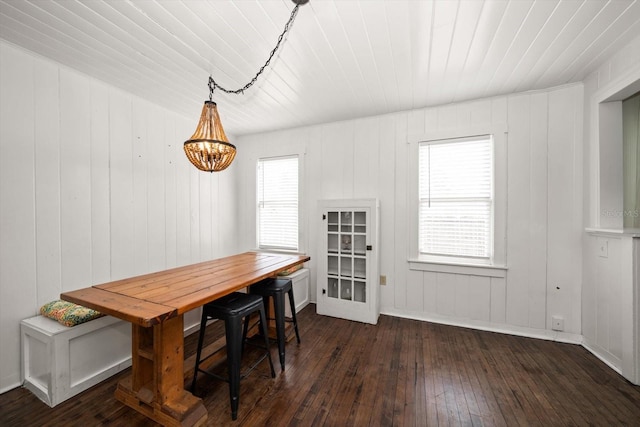 dining space featuring wood-type flooring and wood ceiling