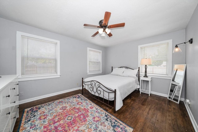 bedroom with wood finished floors, baseboards, and ceiling fan