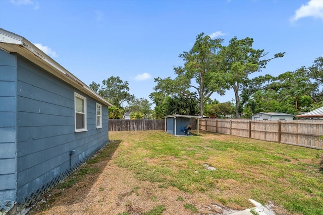 view of yard featuring a storage shed and an outbuilding