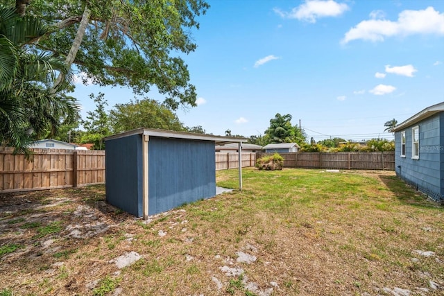 view of yard with a storage shed and an outdoor structure