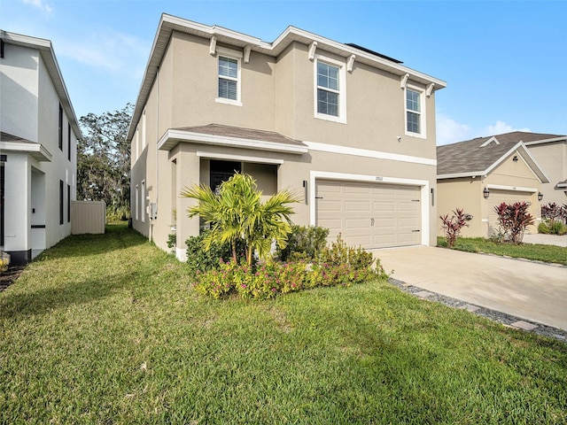 17012 Oval Rum Dr, Wimauma, FL 33598 - view of front of property featuring stucco siding, concrete driveway, an attached garage, and a front lawn
